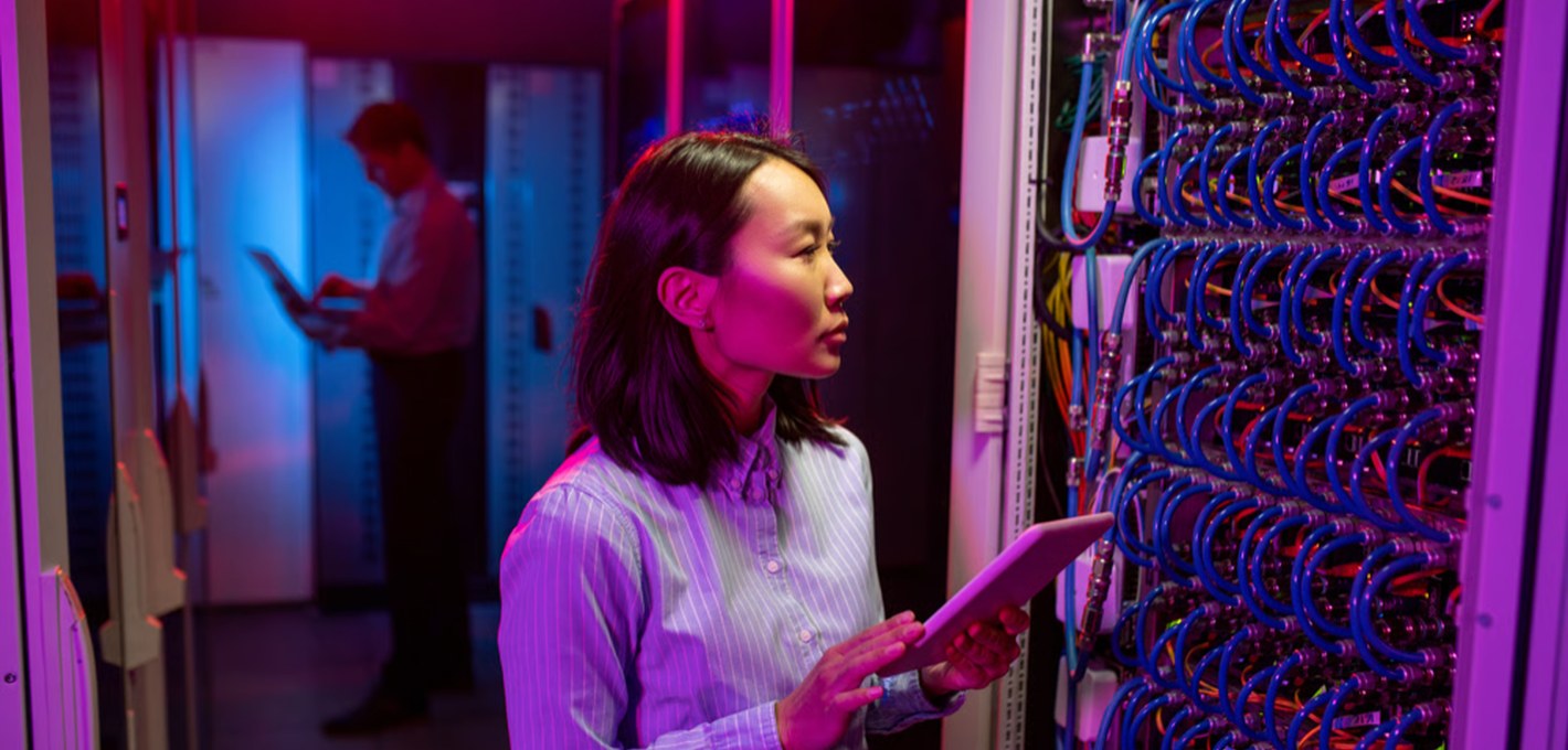 Network support engineer in front of infrastructure racks